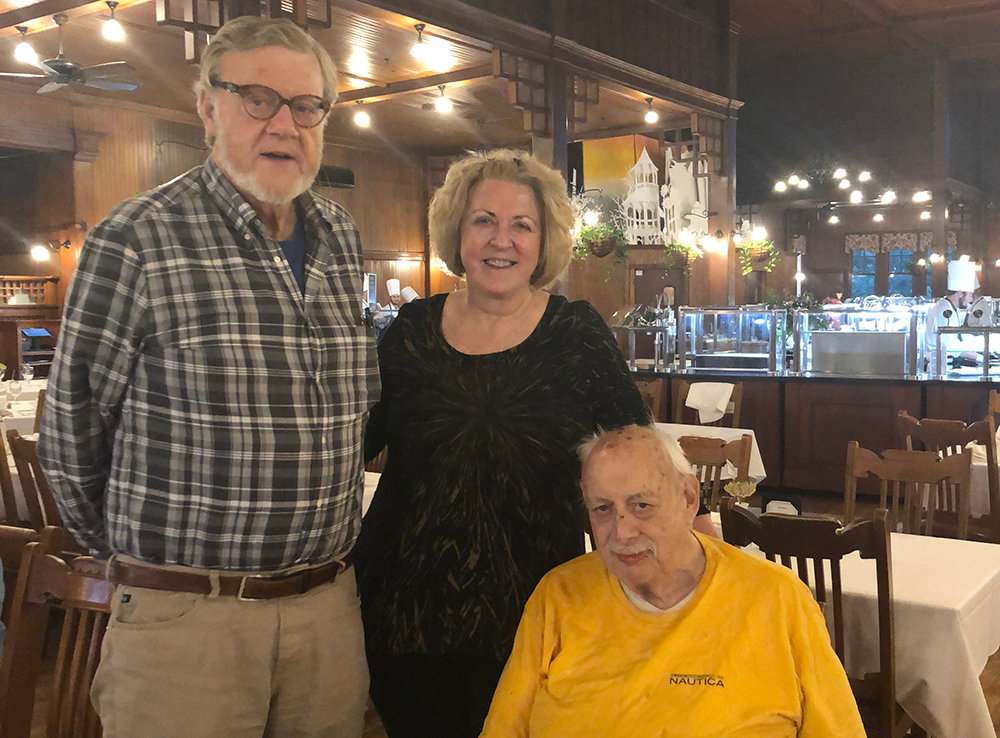 Craig McKinney (seated) visits with his sister Linda Sullivan and brother Bruce McKinney.